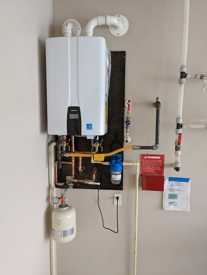 Professional plumber installing copper piping in a Flower Hill home